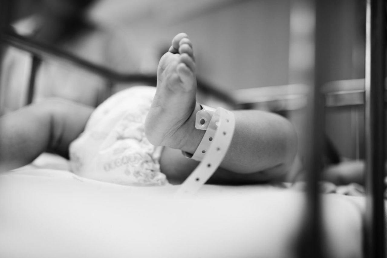 grayscale-photography-of-toddler-sleeping-on-hospital-bed