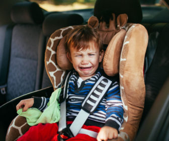 upset-child-in-car-seat-AdobeStock_96733919