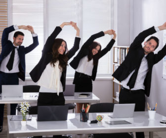 office-staff-exercising-at-their-desks-adobeStock_207357302