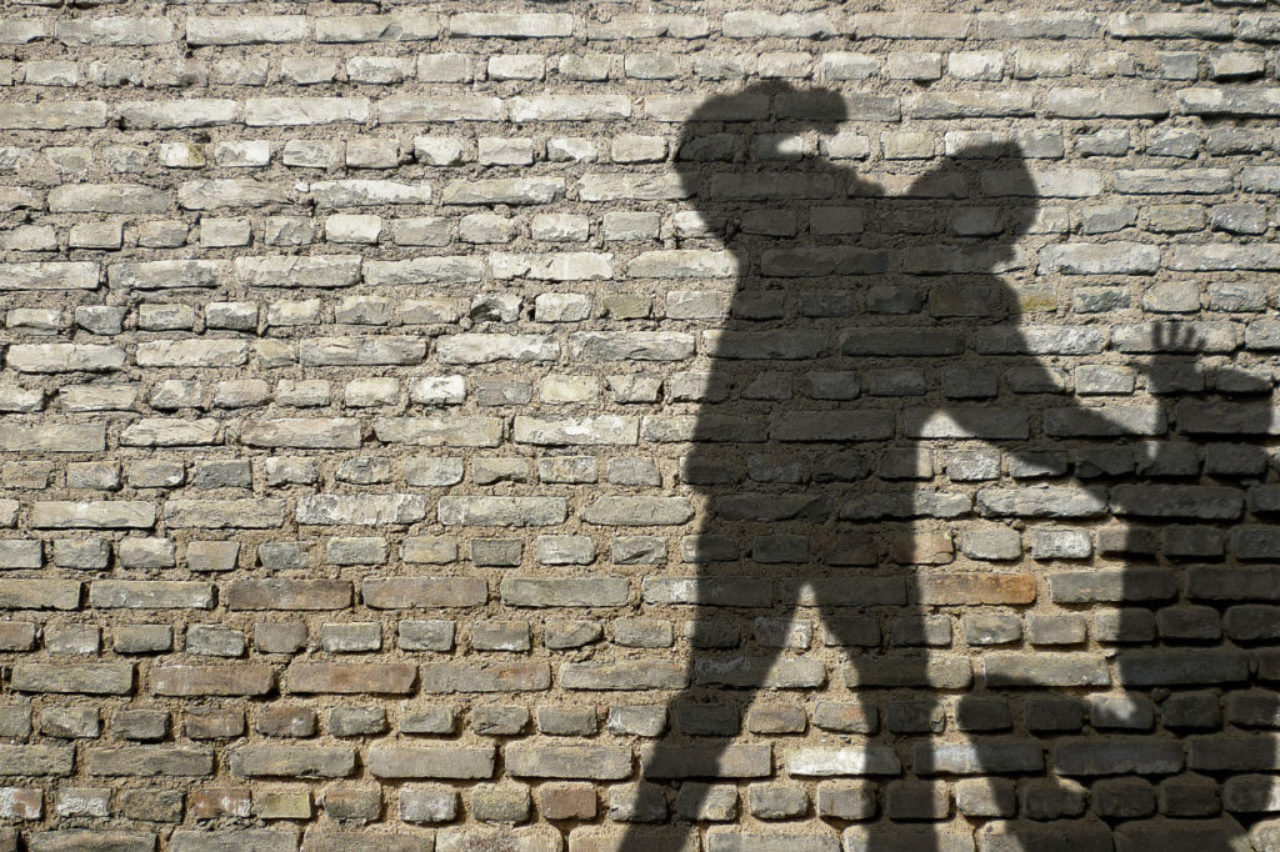 shadow-man-fighting-against-brick-wall