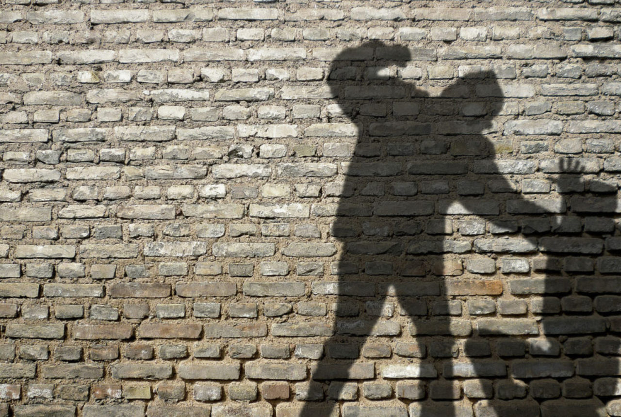 shadow-man-fighting-against-brick-wall