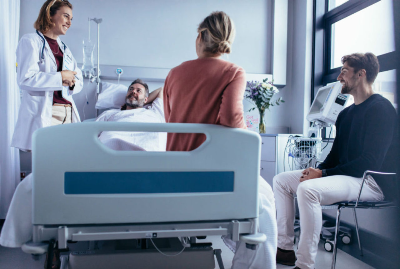 female-doctor-with-family-patient-in-hospital-room