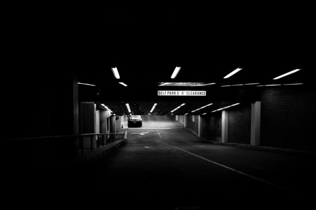 black-and-white-car-in-dark-underground-parking