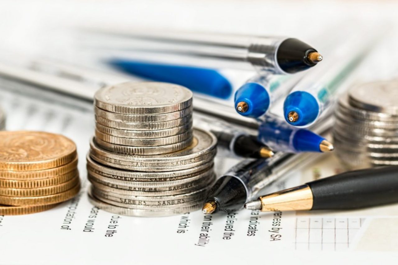 coins-pens-on-paper-with-text