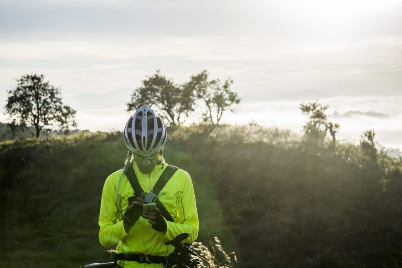 cyclist-stopped-reading-map-on-smartphone