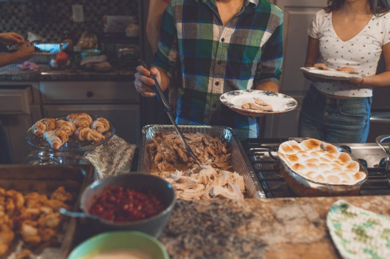 person-picking-food-on-tray