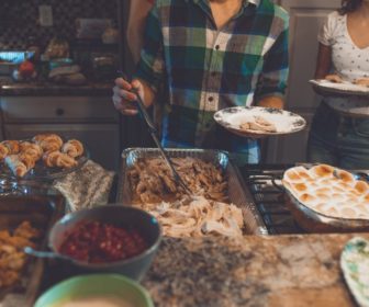 person-picking-food-on-tray