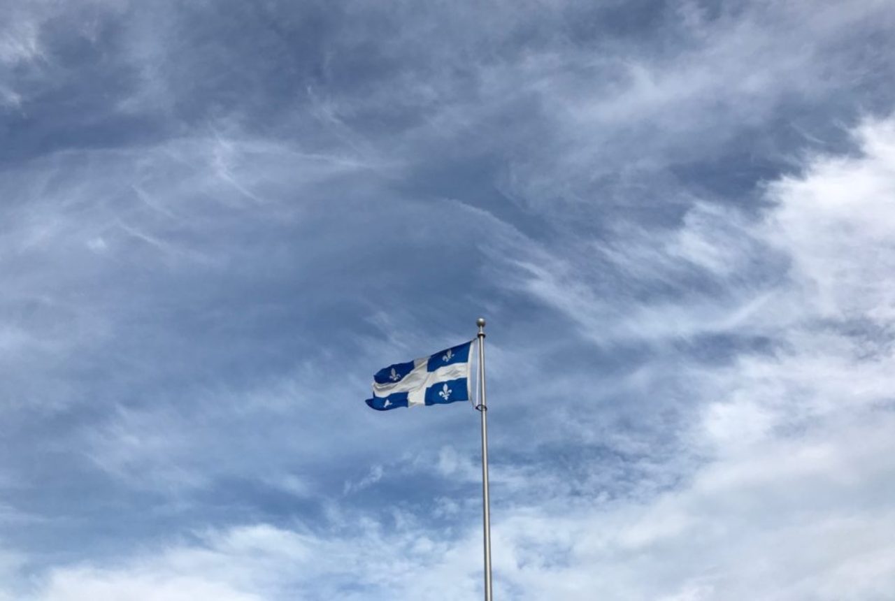 quebec-flag-blue-sky-with-white-clouds