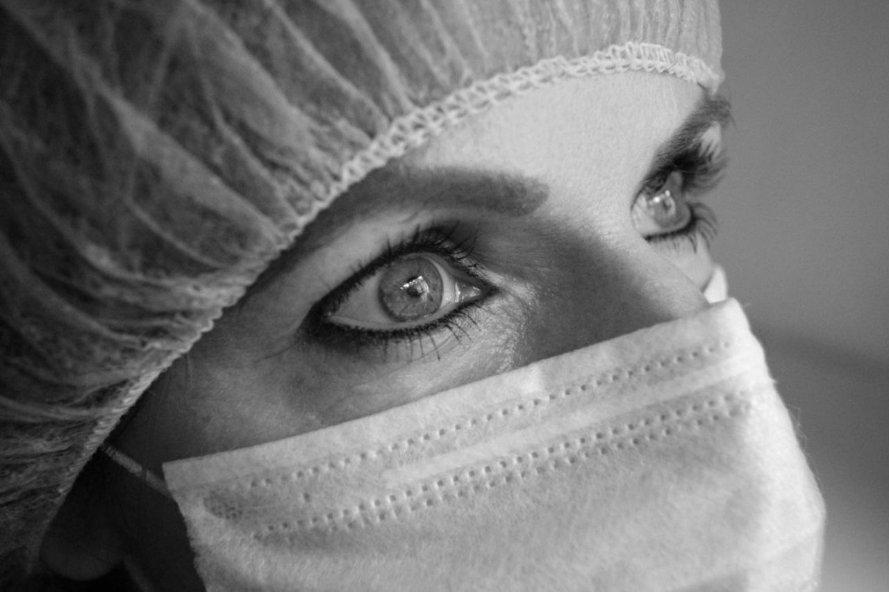 close-picture-of-female-face-wearing-surgical-mask-and-cap-3108660