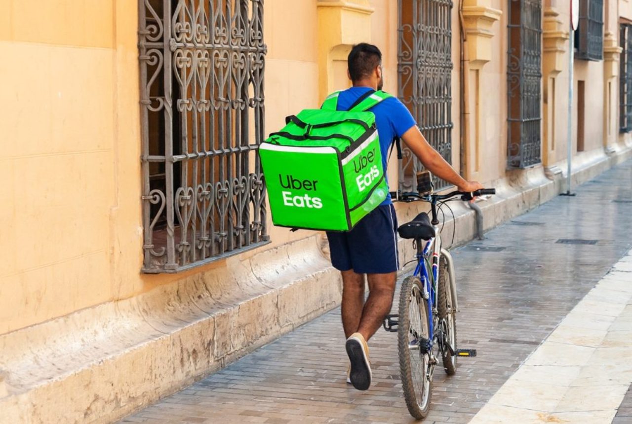 uber-eats-rider-walking-beside-bike