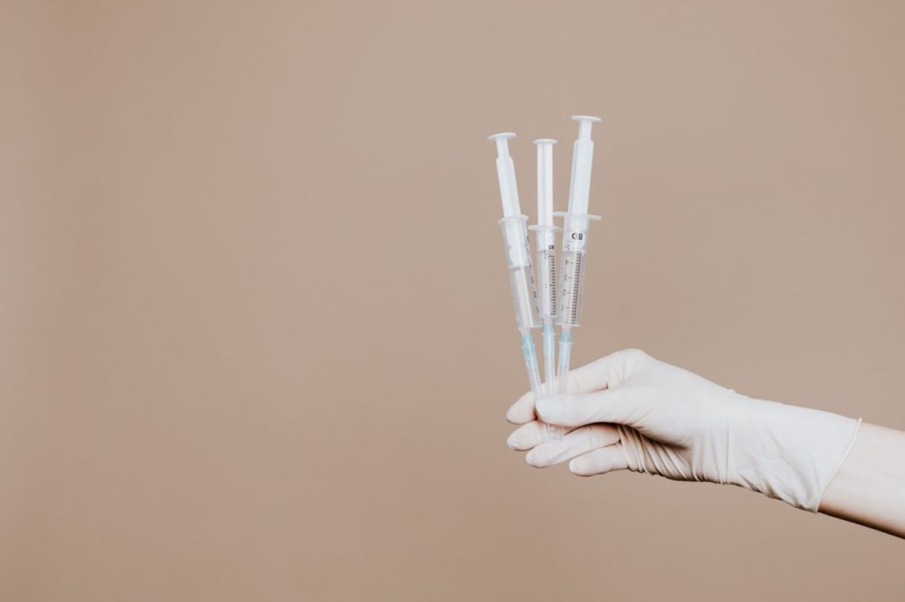 person-holding-three-syringes-with-medicine